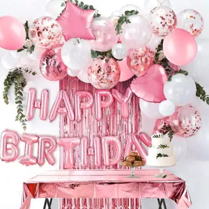 Rose gold birthday party decoration set with foil letter balloons, tinsel curtain and tablecloth.