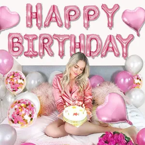 Detail view of the rose gold birthday balloon set featuring foil letter balloons and heart decor.