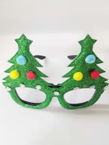Christmas tree glasses detail view, glitter green party eyewear for holiday decor and fun.