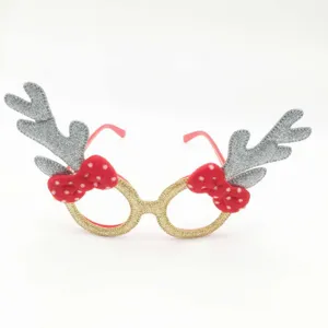Detailed close-up shot of Christmas reindeer antler glasses with glitter gold frame and bow.