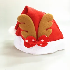 Detail view of red felt Christmas hat with reindeer antlers and bow, festive holiday party prop.