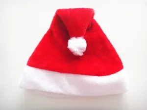 Christmas hat detail shot, red plush santa hat with white fluffy trim for holiday party decor.