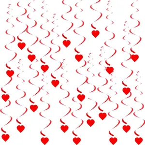 Detailed view of red hanging swirl decorations with heart pendants for romantic party layout.