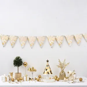 Gold 30th birthday party banner setup with decorative gift boxes and table staging scene.
