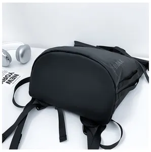 Close-up of black casual backpack detail, showing durable fabric and large travel capacity.