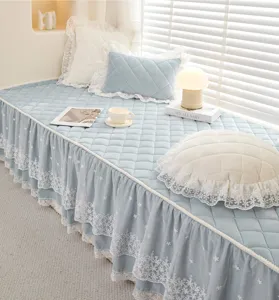 Close-up detail of the soft blue quilted bay window cushion featuring delicate white lace ruffles.