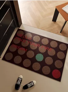 Retro style entrance doormat with textured circles and inspirational English text for home.