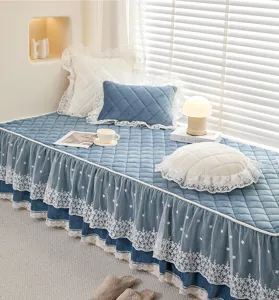 Cozy blue quilted bay window cushion with elegant white lace ruffles for home decor.