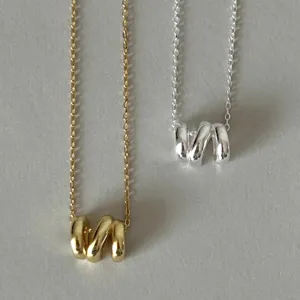 Elegant geometric irregular wave pendant necklace set, stylish gold and silver metal jewelry.