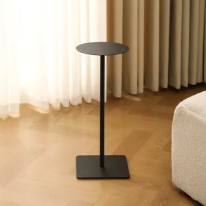 Minimalist black metal plant stand detail, modern round top floor flower pot holder for living room.