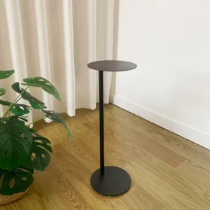 Nordic minimalist black metal floor plant stand, modern round storage display shelf detail.