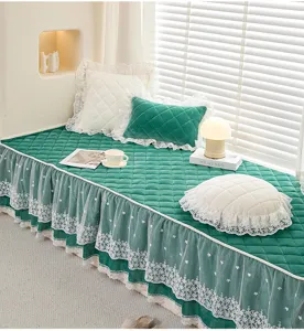 Green quilted bay window cushion featuring elegant white lace ruffles and cozy home.