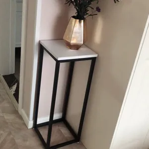 Minimalist floor plant stand with iron metal frame and white top shelf for indoor decor.