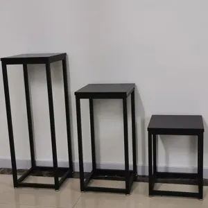 Black metal plant stand set of three tiered display racks for indoor home decor use.
