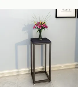 Tall metal plant stand with square wooden top for indoor balcony living room decor.