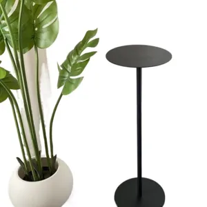 Modern minimalist black metal plant stand round tabletop floor flower rack for indoor home decor.