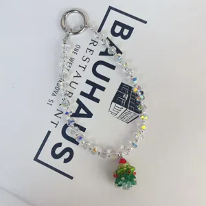 Crystal beaded mobile phone chain with Christmas tree pendant, sparkling winter bag charm accessory.
