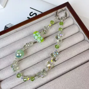 Green crystal beaded phone charm and bag accessory with rose flower ball and butterflies.