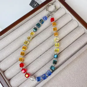 Detailed shot of a colorful crystal beaded phone charm wrist strap in a display tray