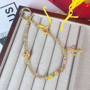 Crystal beaded phone chain with lucky charms, alloy metal hardware, stylish bag and key pendant.