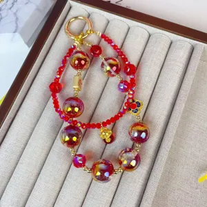 Red crystal beaded phone charm keychain, lucky golden accessory pendant for bags keys daily wear.