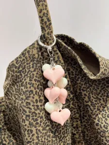 Acrylic resin heart keychain bag charm detail showing pink white cute accessory pendant.