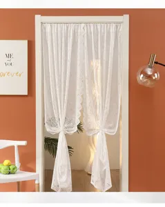 Detailed view of white lace door curtain, elegant sheer fabric bedroom partition.