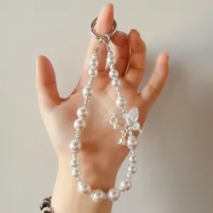 Pearl butterfly beaded phone charm lanyard and keychain wrist strap accessory detail view.