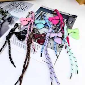 Colorful bow heart bag pendant keychain with braided rope, stylish accessory in multiple colors.