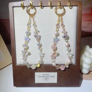 Detail shot of luxury beaded phone strap with crystal beads, pearls and starfish charms.
