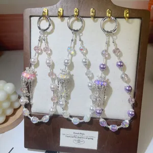 Exquisite crystal pearl beaded detail, elegant short wrist lanyard charm for phone case.