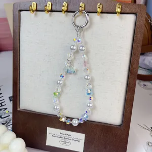 Detailed view of the luxury beaded phone charm strap with crystal beads and butterfly pendant.