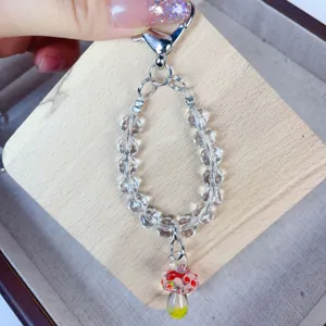 Handmade lampwork crystal mushroom charm detail view clear beaded phone lanyard accessory