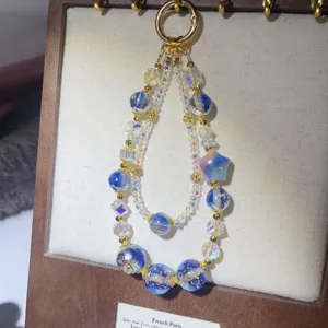 Double layer blue beaded phone charm with crystal star pendant, elegant handmade keychain accessory.