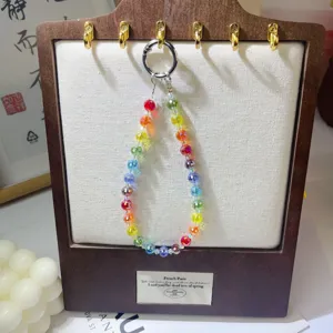 Detailed view of colorful crystal beaded phone strap and wrist lanyard on display.
