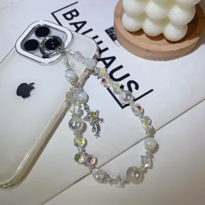 Exquisite sparkling crystal beaded phone charm detail featuring a delicate star pendant.