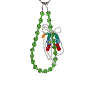 Green crystal beaded phone chain with white bow and colorful flowers, cute bag pendant for women.