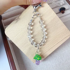 Handmade crystal beaded phone charm with cute lampwork glass mushroom pendant, stylish accessory.