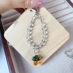 Handmade crystal beaded phone charm with cute lampwork mushroom pendant for women stylish.