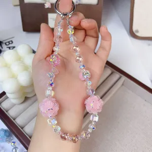 Crystal beaded phone charm with luminous pink rose flower balls for bags and keys detail view.