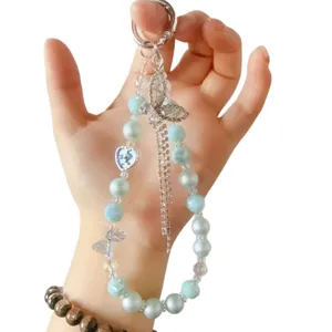 Elegant blue pearl crystal phone charm with rhinestone bow and heart pendant, keychain lanyard.