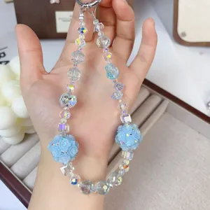 Detailed close-up of the sparkling crystal beaded phone charm with blue rose flower balls.