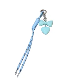 Light blue braided rope keychain with cute bow and heart charm for bag decoration.