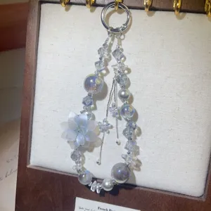 Luxury beaded phone charm and bag pendant with crystal flowers and pearls for women.
