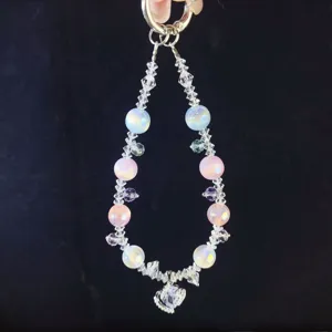 Crystal phone charm detail showing pastel beads, faceted clear crystals and zircon pendant.