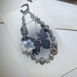 Elegant DIY beaded phone charm with crystal flower pendant and pearls for bags and phones.