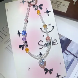 Detailed view of handmade crystal zircon phone chain, sparkling heart pendant with colorful beads.