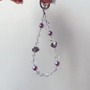 Handmade crystal beaded phone charm detail, purple heart pendant and metal ring clasp.