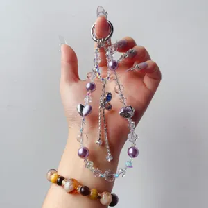 Handmade crystal beaded phone charm with purple beads and alloy heart pendant for women.