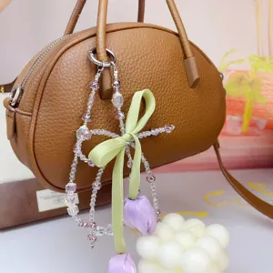 Cute tulip beaded phone chain and bag charm with green bow and purple flowers accessory.